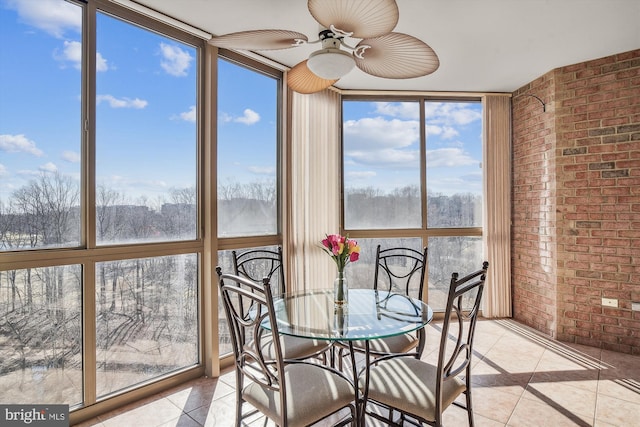 unfurnished sunroom featuring ceiling fan