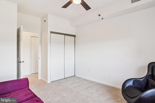 sitting room featuring light carpet, visible vents, baseboards, and a ceiling fan