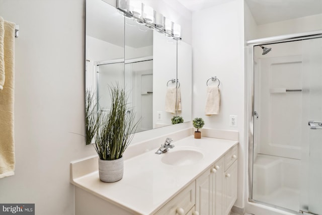 full bathroom featuring a shower stall and vanity