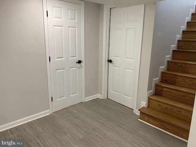 interior space with baseboards and wood finished floors