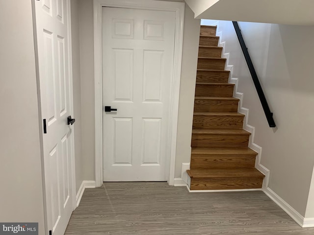 stairs with baseboards and wood finished floors