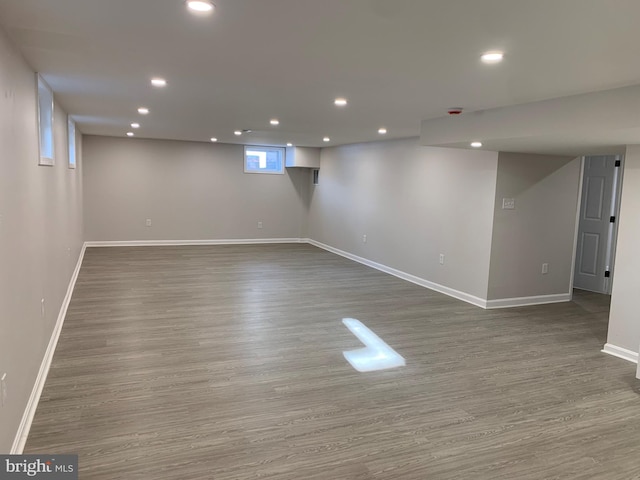 below grade area featuring baseboards, wood finished floors, and recessed lighting