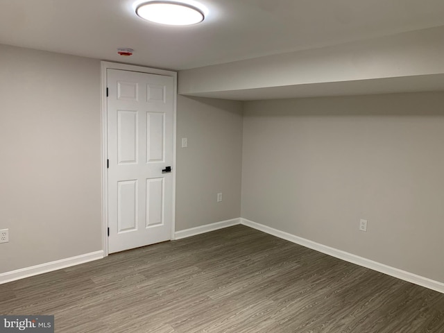 finished basement with baseboards and wood finished floors