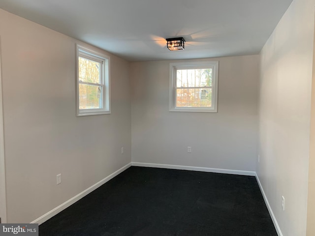 empty room with a healthy amount of sunlight and baseboards