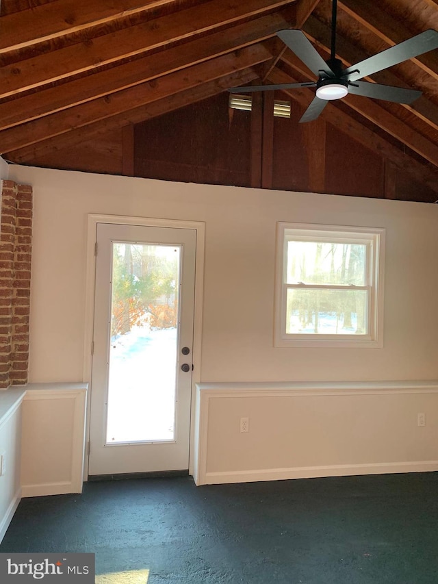 doorway featuring a ceiling fan and vaulted ceiling