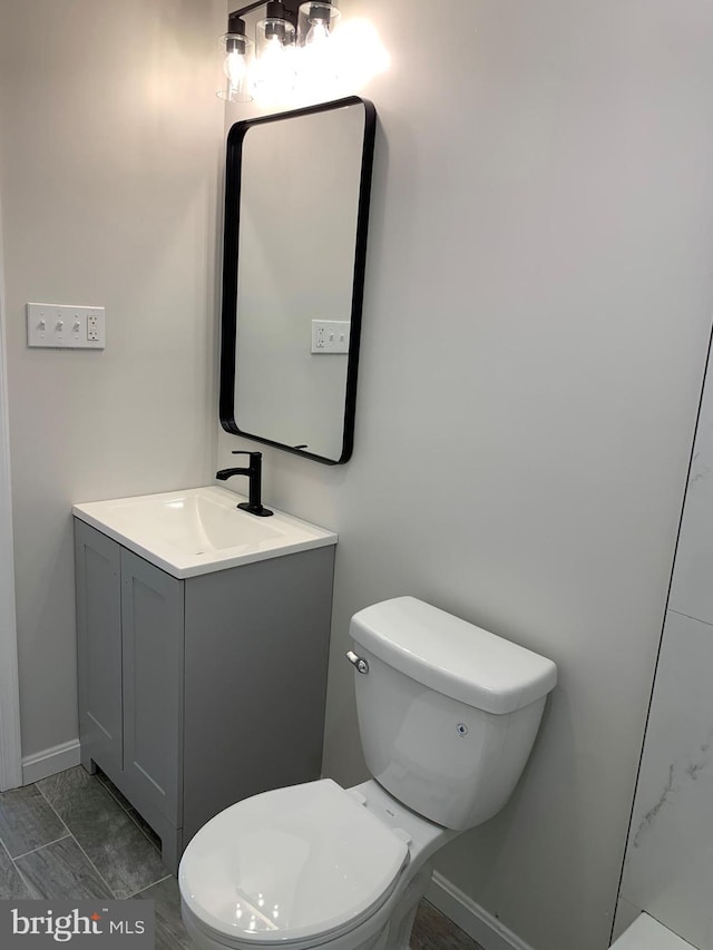 bathroom featuring toilet and vanity