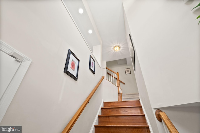 staircase with hardwood / wood-style floors