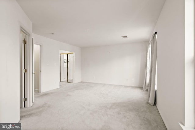 empty room featuring light colored carpet