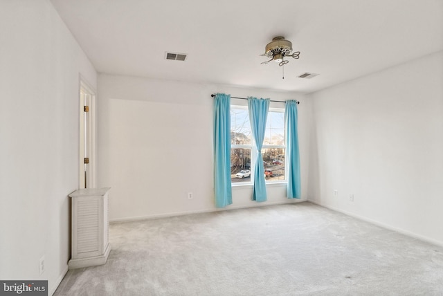 spare room with light colored carpet and ceiling fan