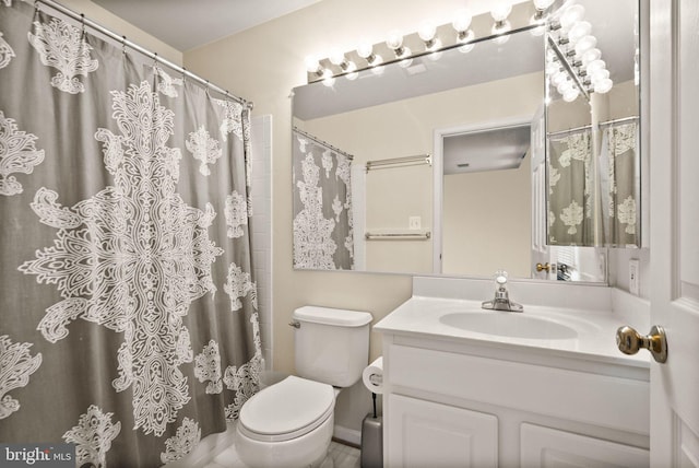 bathroom featuring vanity, toilet, and walk in shower