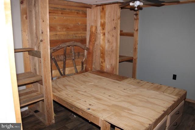 bedroom with wood walls