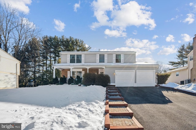 view of front property with a garage and a porch