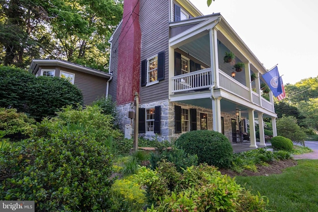 view of side of home featuring a patio area and a balcony