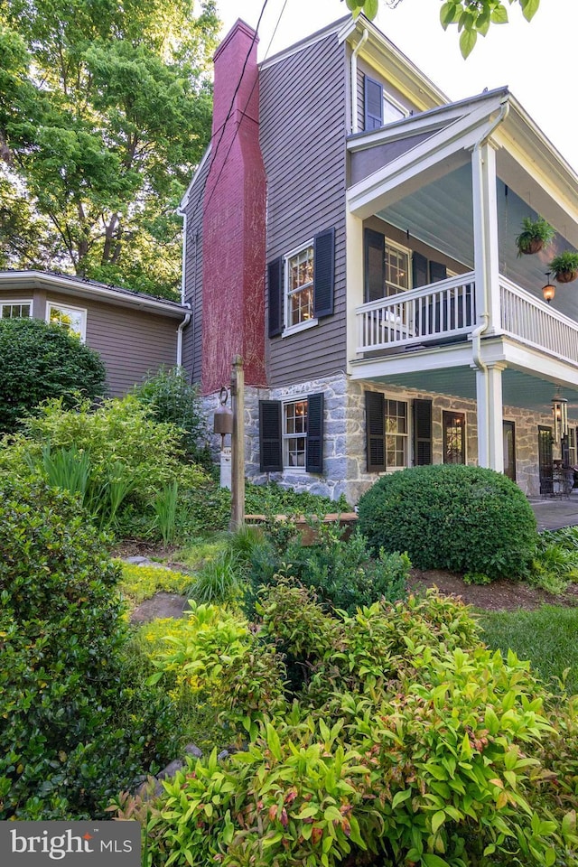 view of side of home featuring a balcony