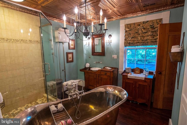 bathroom featuring a chandelier, plus walk in shower, and hardwood / wood-style flooring