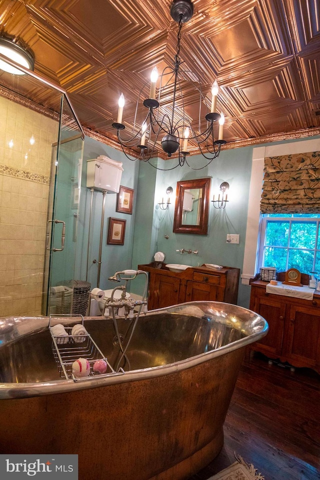 bathroom with vanity, wood-type flooring, a notable chandelier, and a shower with door