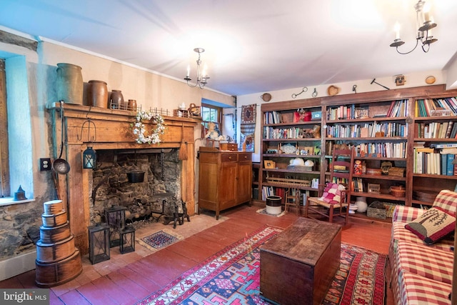 sitting room featuring crown molding, a chandelier, and hardwood / wood-style floors