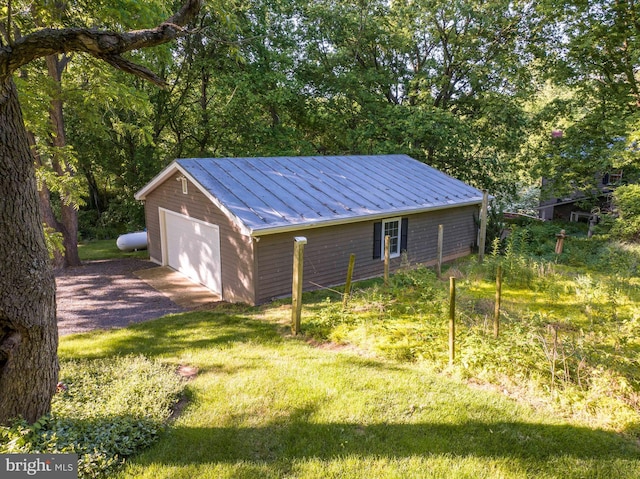 view of outdoor structure with a garage and a yard