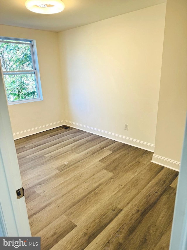 spare room featuring hardwood / wood-style flooring