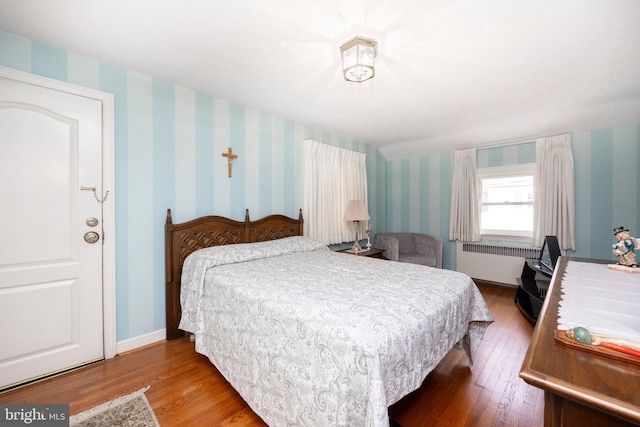 bedroom with hardwood / wood-style flooring