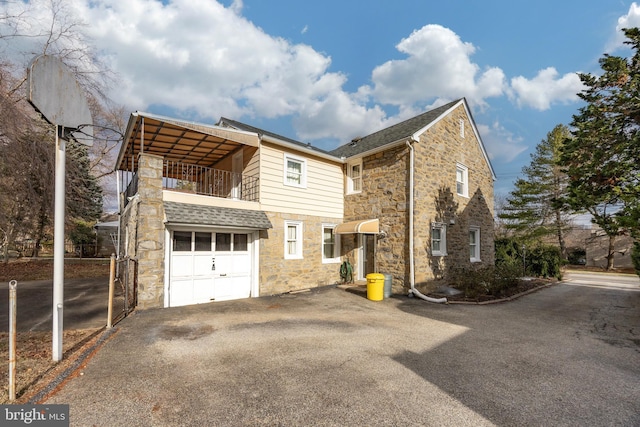 exterior space with a garage and a balcony