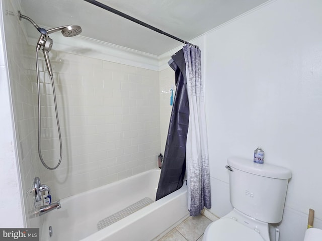 bathroom featuring shower / bath combo with shower curtain, tile patterned floors, and toilet