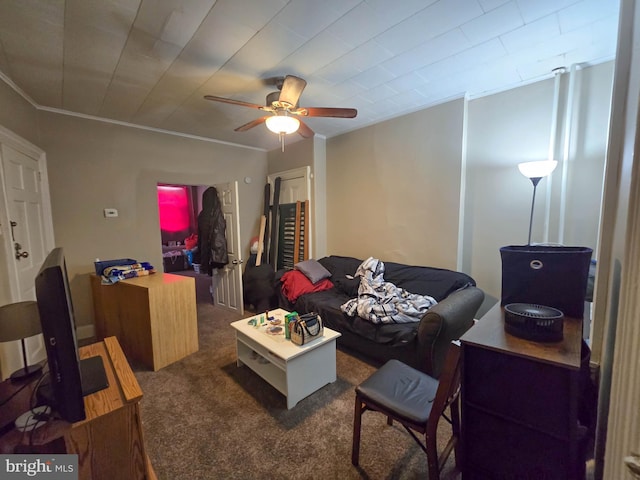 living room with ceiling fan, dark carpet, and crown molding