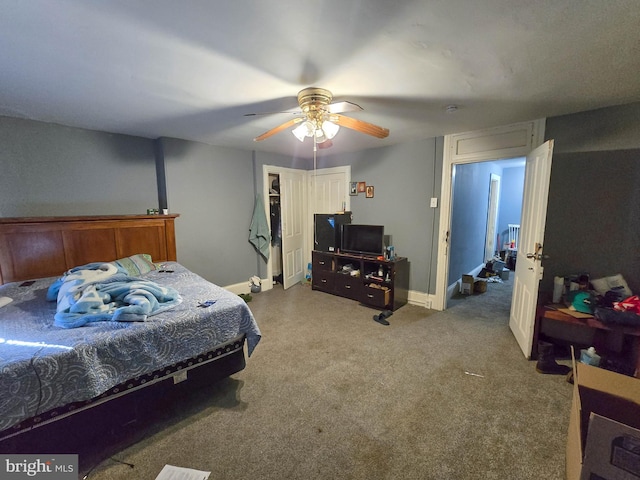 bedroom featuring ceiling fan, a closet, and carpet