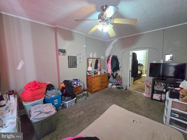 carpeted bedroom featuring ceiling fan and ornamental molding