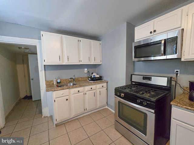 kitchen with white cabinets, sink, stone counters, and stainless steel appliances