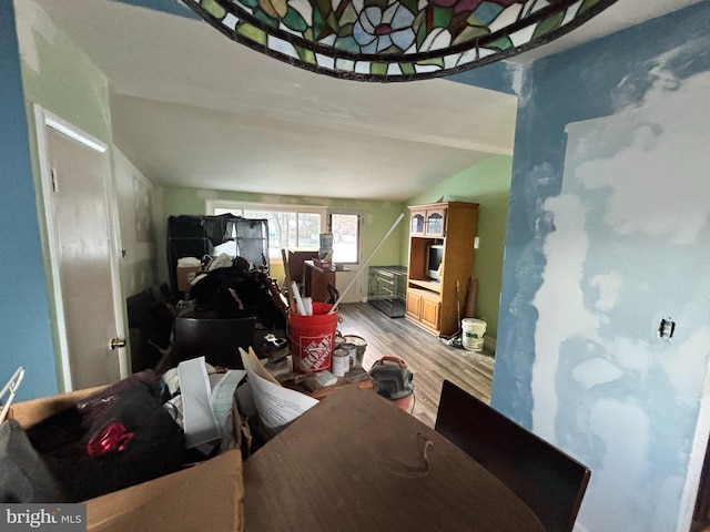 dining room with vaulted ceiling and light hardwood / wood-style floors