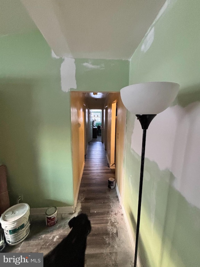 hallway with dark hardwood / wood-style flooring