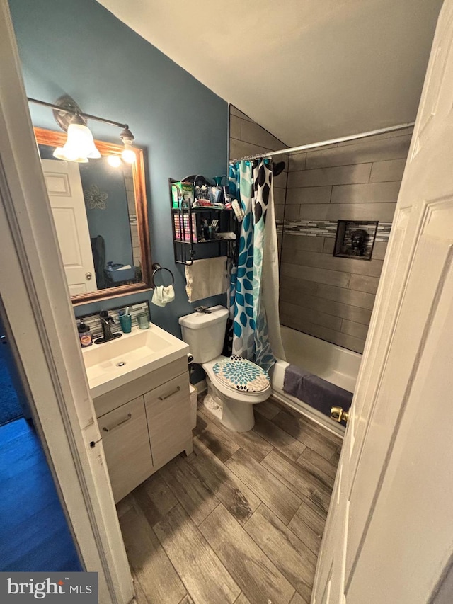 bathroom with toilet, vanity, and a shower with curtain