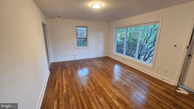 spare room with dark hardwood / wood-style floors