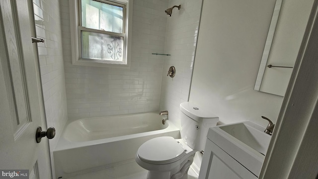 full bathroom featuring toilet, vanity, and tiled shower / bath