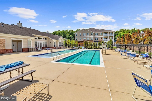 view of pool with french doors and a patio area