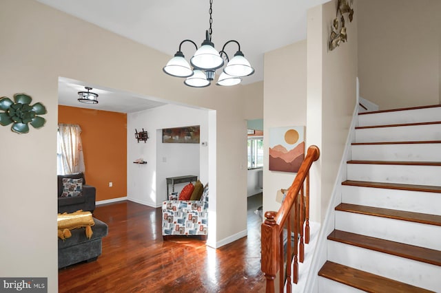 stairs with an inviting chandelier and hardwood / wood-style floors