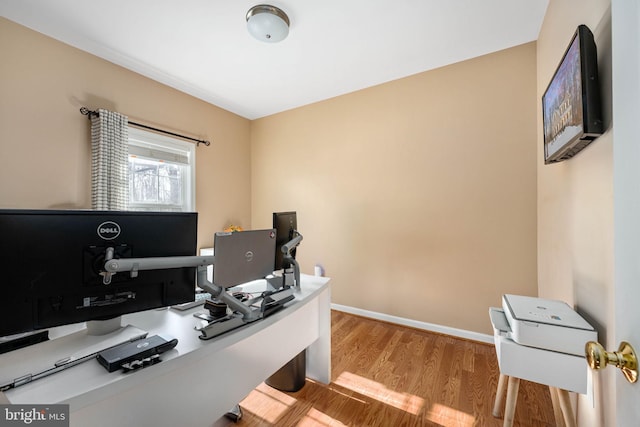 office with light hardwood / wood-style flooring