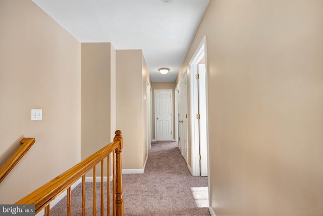 corridor featuring light colored carpet