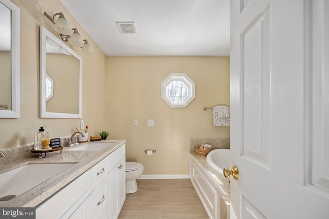 bathroom with a bathtub, toilet, and vanity