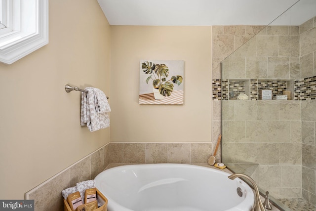 bathroom featuring tiled bath