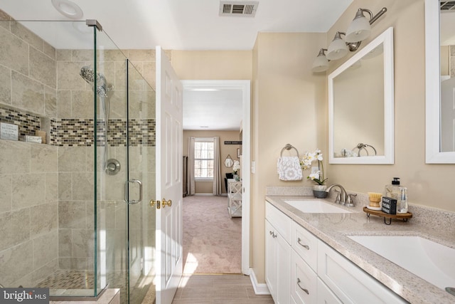 bathroom with walk in shower and vanity