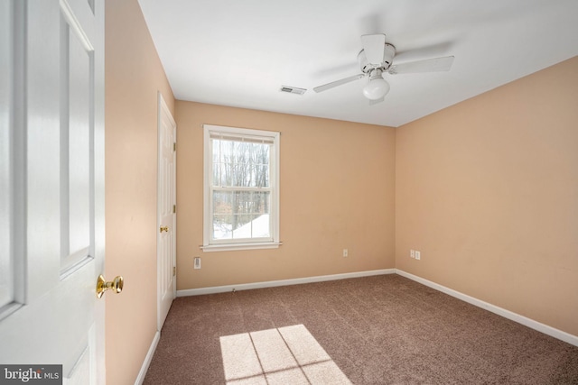 carpeted spare room with ceiling fan