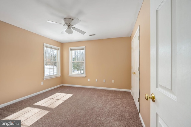 spare room with ceiling fan and carpet floors