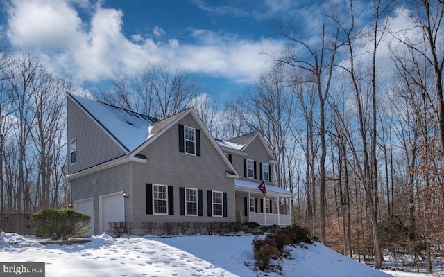 view of front facade featuring a garage and a porch