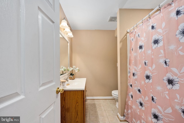 bathroom featuring tile patterned floors, vanity, and toilet