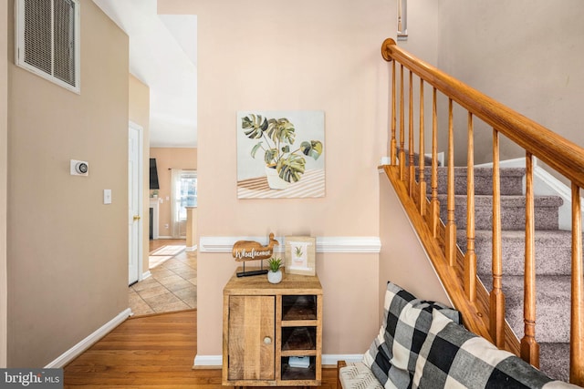 stairs featuring hardwood / wood-style flooring