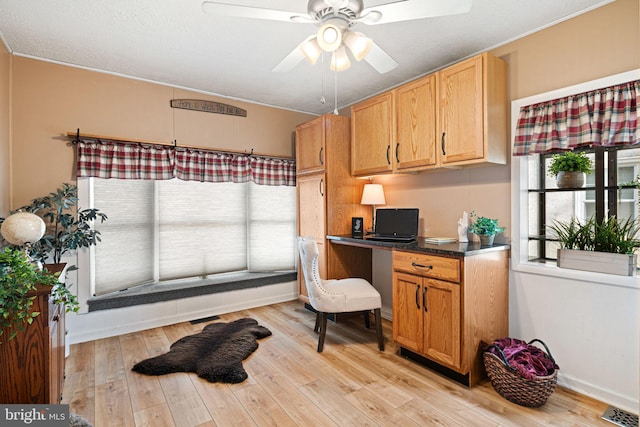 office with ceiling fan, built in desk, and light hardwood / wood-style floors