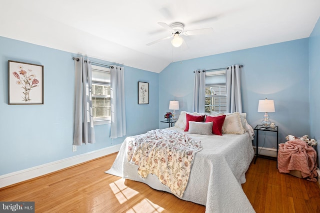 bedroom featuring hardwood / wood-style flooring, ceiling fan, and lofted ceiling