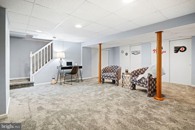 basement featuring a paneled ceiling and carpet floors